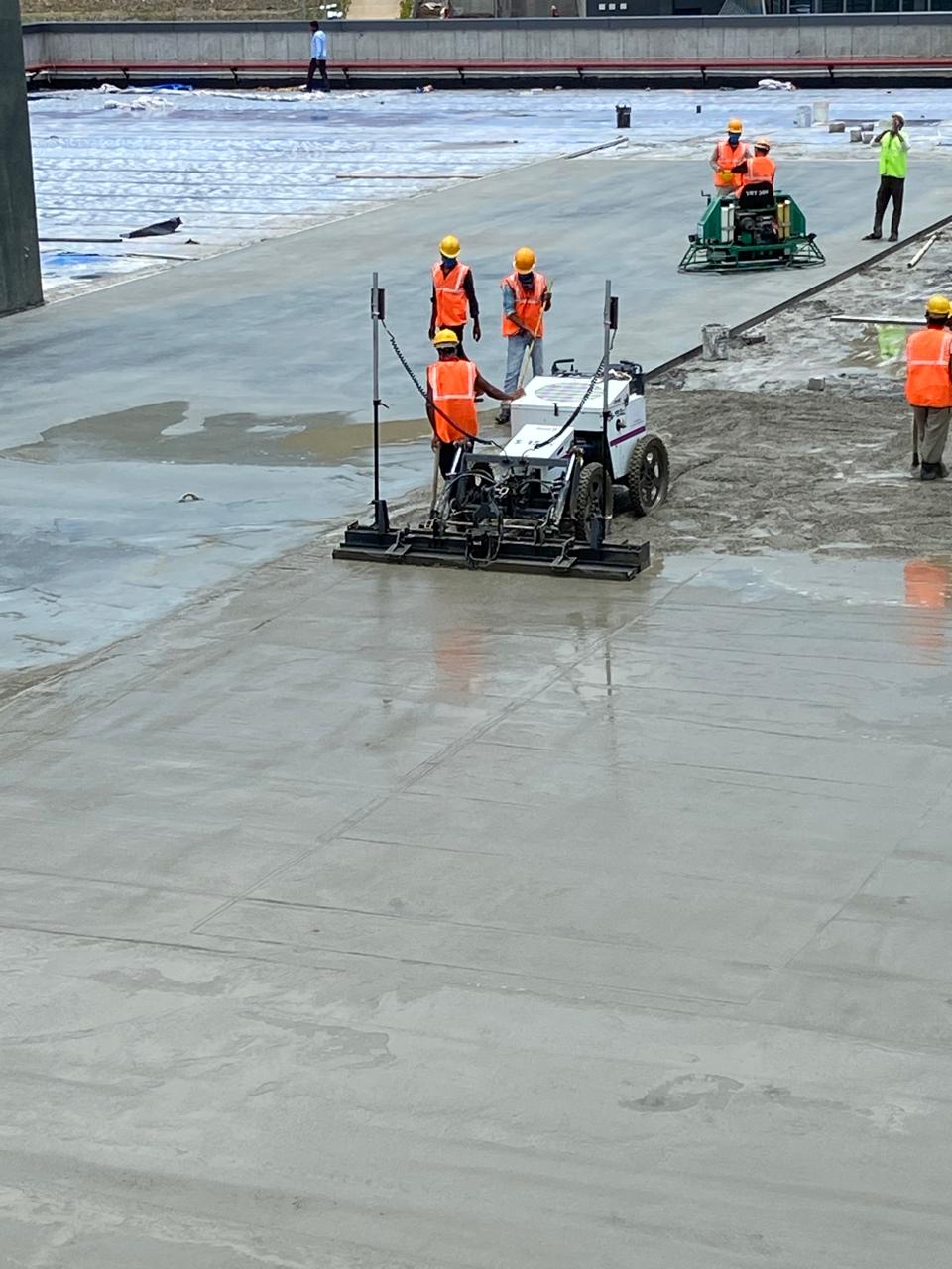 Power trowel finishing on an industrial concrete floor